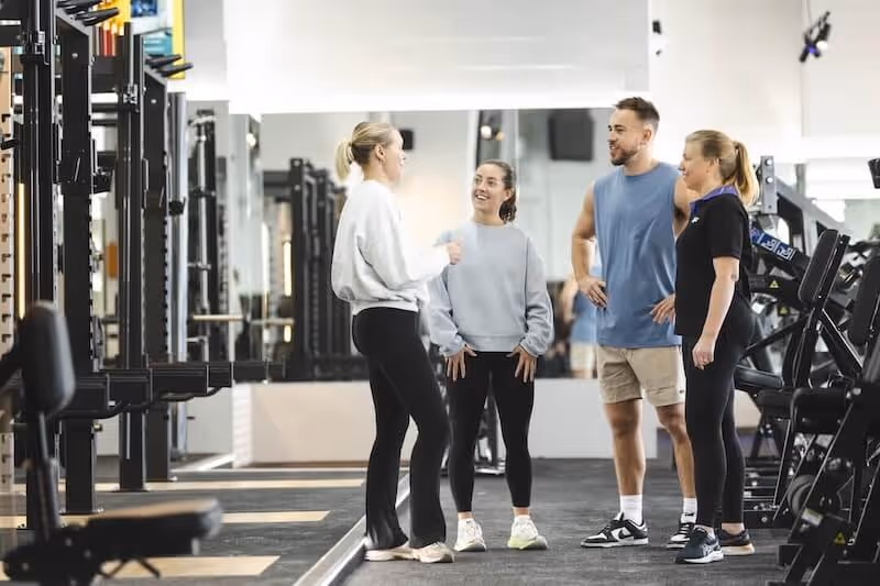 Anytime Fitness Australia coach leading a small group training session inside the gym.